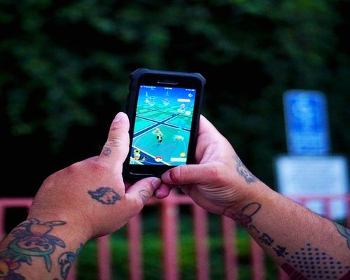 Angled smartphone showing the fictional Zone Builder Crew creative game